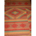 Two Contemporary kilim rugs, with multi-coloured geometric design, fringed. L.176cm W.