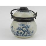 A Chinese blue and white porcelain opium jar, with swing handle, bears character marks to base.