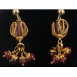 An unusual pair of yellow gold and pink sapphire pendant drop earrings.