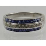 An 18 carat white gold, diamond, and sapphire channel set band ring.