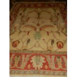 An Afghan cream ground Zeigler rug, having scrolling foliage to centre, multi-border and fringed. L.