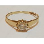 A 9 carat yellow gold ring, set with a cubic zirconium.