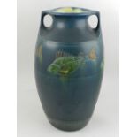 A 20th century twin handled pottery vase, decorated with fish on a blue ground.