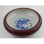 A Chinese sang de boeuf bowl, the interior decorated in blue and white with dogs of fo. H.12cm D.