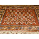 A Moroccan brown ground rug, decorated with stylised flowers to centre, multi-bordered and fringed.