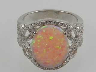 A silver, pink opalite, and cubic zirconia set cocktail ring.