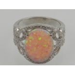 A silver, pink opalite, and cubic zirconia set cocktail ring.