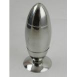 A silver plated novelty cocktail shaker in the form of a missile.