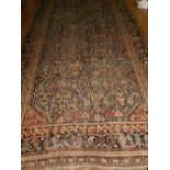 A 1920s Persian blue ground Shiraz carpet, the centre with stylised flowers and geometric symbols,