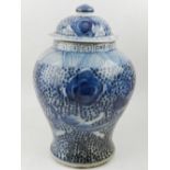 A pair of Chinese blue and white porcelain urns, one having cover, decorated with flowers on a