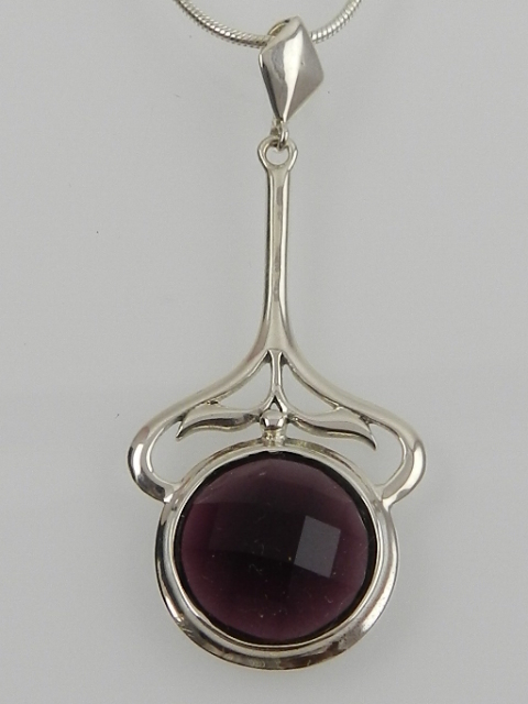 A silver and faceted amethyst set pendant on a silver chain.