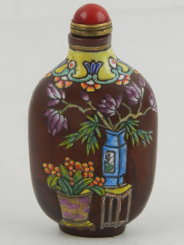 A Chinese snuff bottle, polychrome decorated with flowers in vases. H.7.