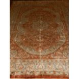 A part silk brown ground Kashmiri rug, having lobed floral medallion to centre,