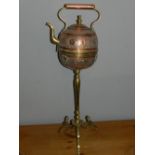 A North African brass tea pot, on tripod stand.