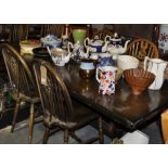 A rectangular oak refectory dining table together with a set of wheel back dining chairs