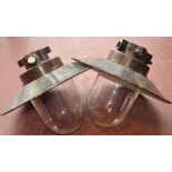 A pair of East European industrial style ceiling lights with enameled circular shades,