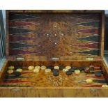 A thuya wood folding backgammon box with stained and natural wood pieces