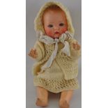 A 1930s/40s open mouthed doll with painted features and moulded ginger hair,