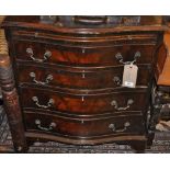 A small reproduction Georgian design mahogany serpentine chest, fitted brushing slide,