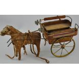 An early 20th century painted tin plate dog cart, the horse covered in pony-shin, H. 16cm.