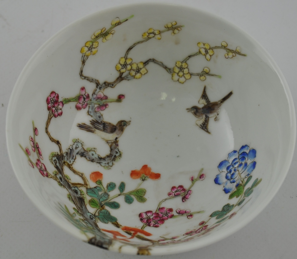 A Chinese Famille rose bowl, depicting birds amongst trees,