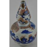 A Chinese blue and white double gourd vase with copper red decoration,
