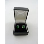 A pair of jade ear studs, claw set in white metal, stamped 925, 2.1g.