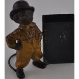 An early 20th Century gold painted spelter matchbox holder modelled as a boy smoking a cigar with