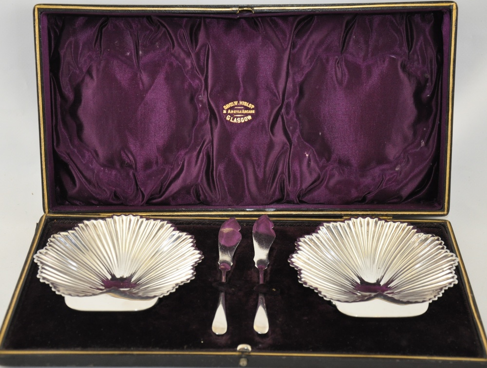 A pair of Victorian cast silver shell shaped butter dishes and knives, Sheffield,