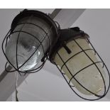 A pair of East European industrial ceiling lights with moulded caged shades