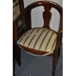 A pair of Edwardian tub shaped chairs, with vase shaped splats and stripped floral seats,