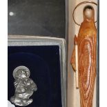 A boxed 800 standard silver Italian icon of The Madonna and Child together with a religious carving