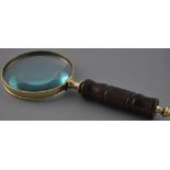 A brass bound table magnifier with wooden handle