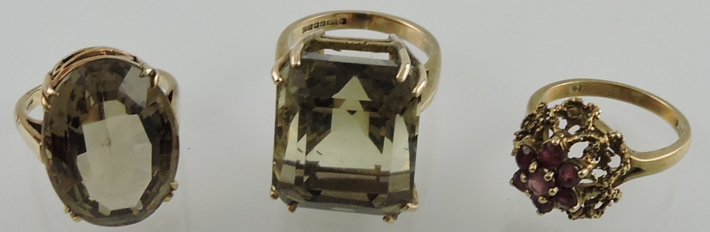 Three 9ct yellow gold dress ring set smokey quartz and garnet