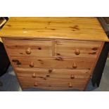 A small pine four draw chest of drawers