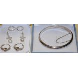 An engraved silver bangle together with three pairs of assorted silver hoop and pendant earrings