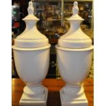 A pair of white crackle glazed vases and covers on beaded square bases,