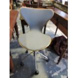 A Fritz Hanson bent ply and chrome swivel chair with five prong base