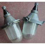 A pair of East European industrial ceiling lights with ribbed moulded shades