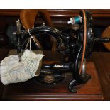 A late 19th Century Willcox and Gibbs sewing machine on mahogany plate