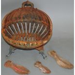 An oval form cast iron fire basket, raised on short pad feet, W.