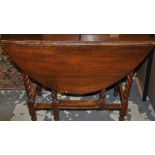 A 17th century style oak drop leaf table, with barley twist legs, W. 91cm..