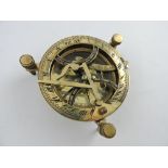 A brass table sundial, with three adjustable feet, D. 11cm.