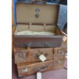 A pair of early 20th Century tan leather suitcases together with a later revelation expanding case