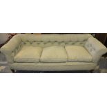 A Victorian mahogany Chesterfield settee with drop arm,