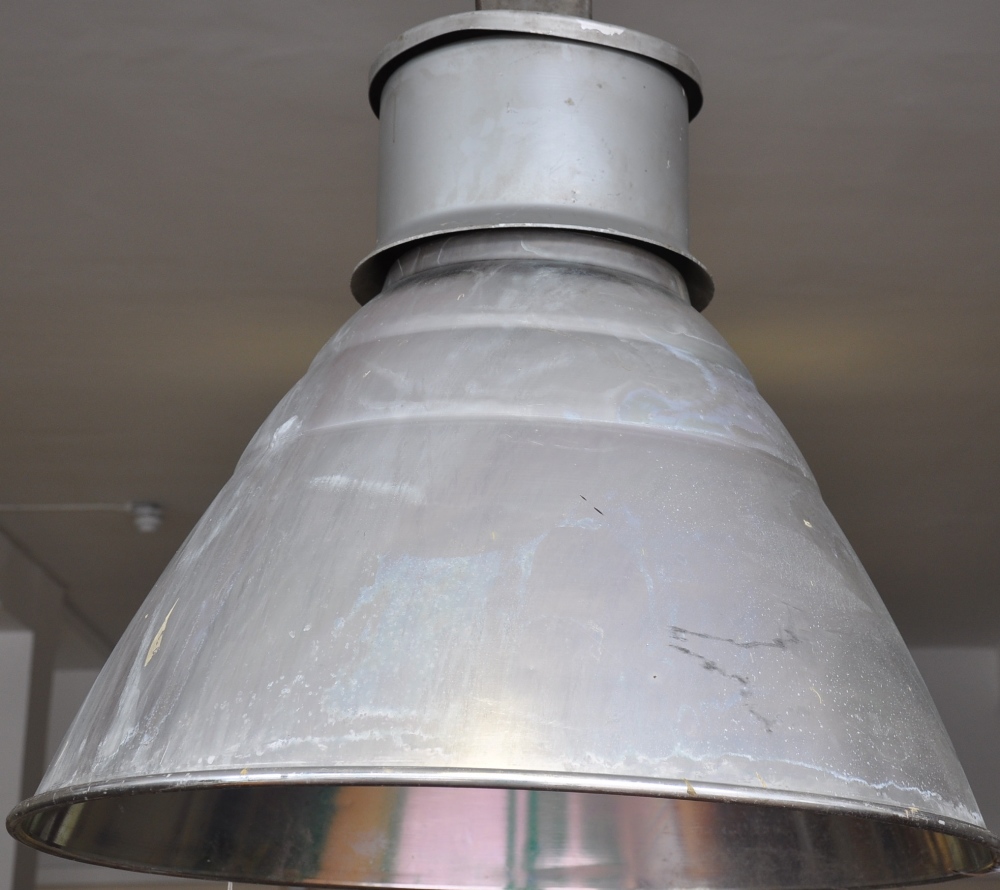 A large industrial style aluminium ceiling light, with conical shade,