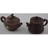 A Chinese Yixin terracotta teapot decorated with peaches together with another styled as a bamboo