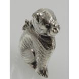 A white metal vesta case in the form of a dog, stamped Sterling. H.5cm