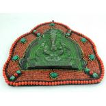 A South East Asian wall ornament, moulded with elephant to centre within red and turquoise beaded