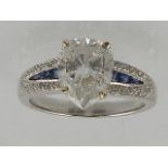 A white metal diamond and sapphire set dress ring, diamond weight approx. 2.14ct, the shank